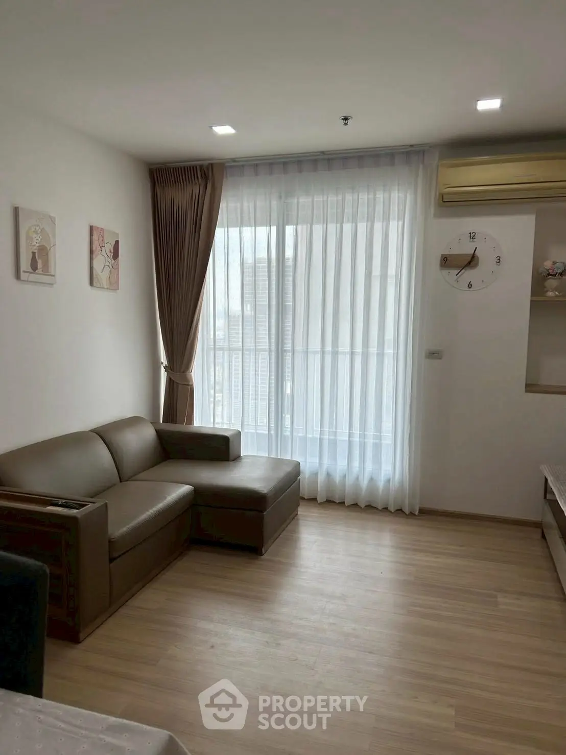 Modern living room with large window and stylish furniture in a cozy apartment.