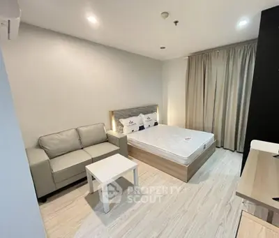 Modern bedroom with cozy sofa and stylish decor