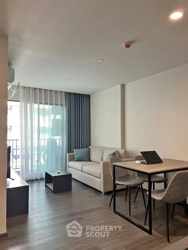 Modern living room with sleek furniture and natural light, perfect for urban living.