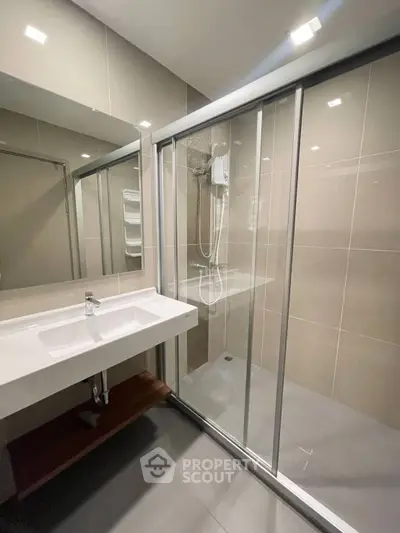 Modern bathroom with sleek shower enclosure and stylish sink