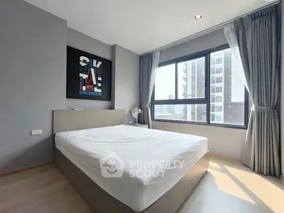 Modern bedroom with large window and city view in a stylish apartment