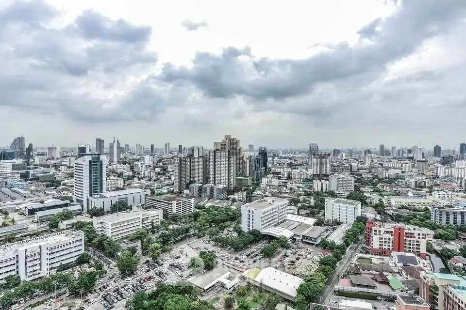 Stunning cityscape view showcasing a vibrant urban skyline with towering buildings and lush greenery.