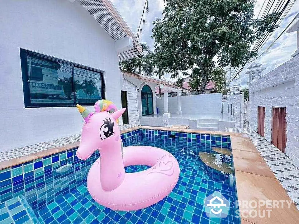 Charming pool area with unicorn float, perfect for relaxation and entertainment in a modern home.