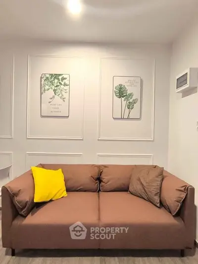Stylish living room with modern brown sofa and decorative wall art