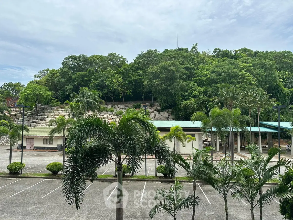 Scenic view of lush greenery and parking area in a serene real estate setting.