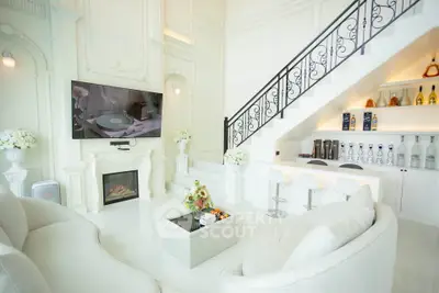 Luxurious white living room with elegant staircase and modern decor