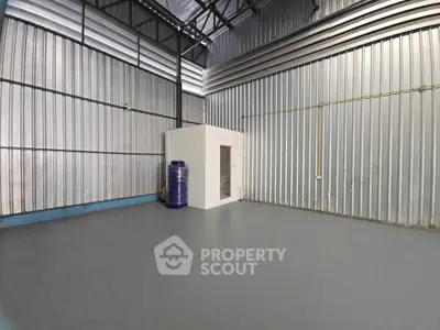 Spacious industrial warehouse interior with metal walls and high ceiling