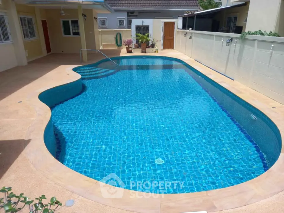 Stunning private pool area in a serene residential setting, perfect for relaxation and entertainment.