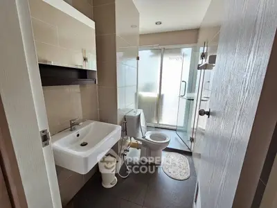 Modern bathroom with sleek fixtures and glass shower enclosure