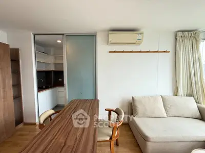 Modern living room with wooden table, cozy sofa, and air conditioning in a bright apartment.