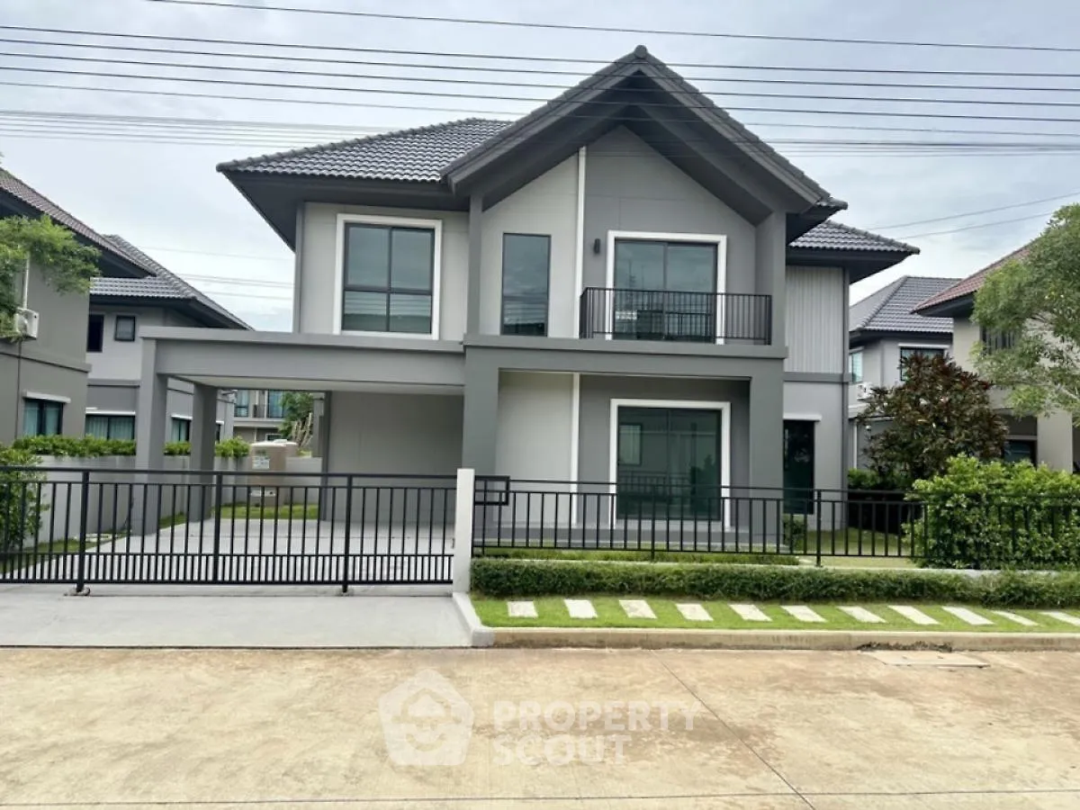 Modern two-story house with sleek design and spacious driveway in a serene neighborhood.