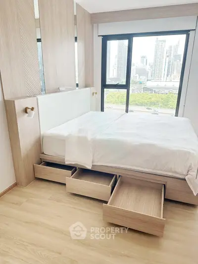 Modern bedroom with city view, featuring built-in storage and sleek design.