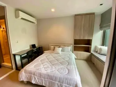 Modern bedroom with cozy bed, built-in wardrobe, and study desk in stylish apartment.