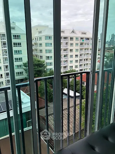 Stunning urban view from a modern apartment balcony with cityscape backdrop.