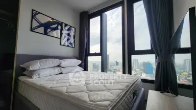 Modern bedroom with stunning city view and large windows, featuring stylish decor and comfortable bedding.