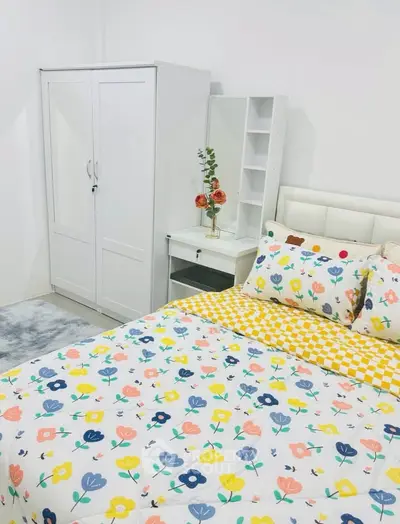 Charming bedroom with floral bedding and white furniture, perfect for a cozy and inviting atmosphere.