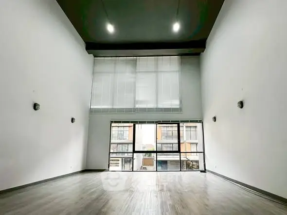 Spacious modern living room with high ceilings and large windows