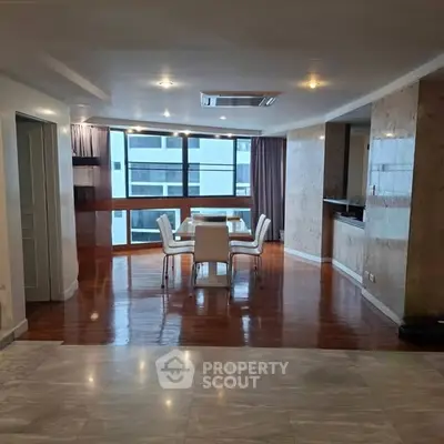 Spacious dining area with modern design and large windows offering natural light.