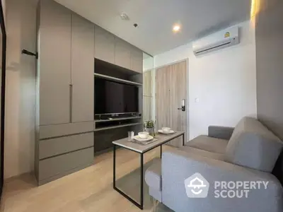 Modern living room with sleek furniture and built-in storage in a stylish apartment.