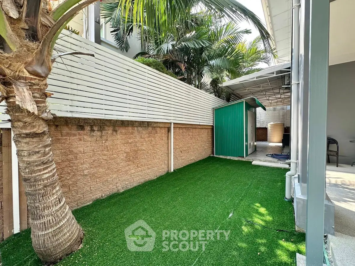 Charming outdoor garden space with lush greenery and a cozy shed, perfect for relaxation and leisure activities.