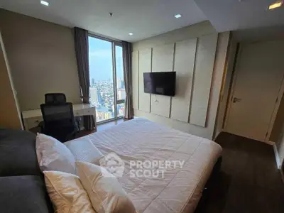Modern bedroom with city view, featuring a comfortable bed and wall-mounted TV.