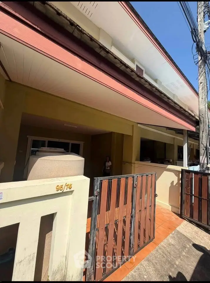 Charming two-story home with gated entrance and spacious front patio, perfect for family living.