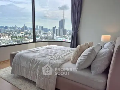Luxurious bedroom with panoramic city view and elegant decor