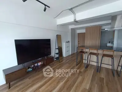 Modern living room with sleek wooden flooring and stylish furniture