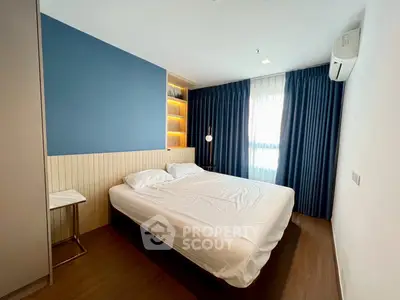 Modern bedroom with stylish blue accent wall and cozy lighting