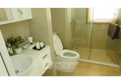 Modern bathroom with sleek fixtures and glass shower enclosure