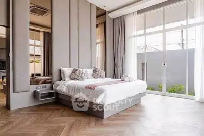 Luxurious modern bedroom with large windows and elegant decor