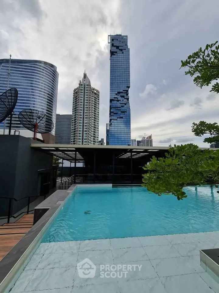Luxurious rooftop pool with stunning city skyline view in modern high-rise building.