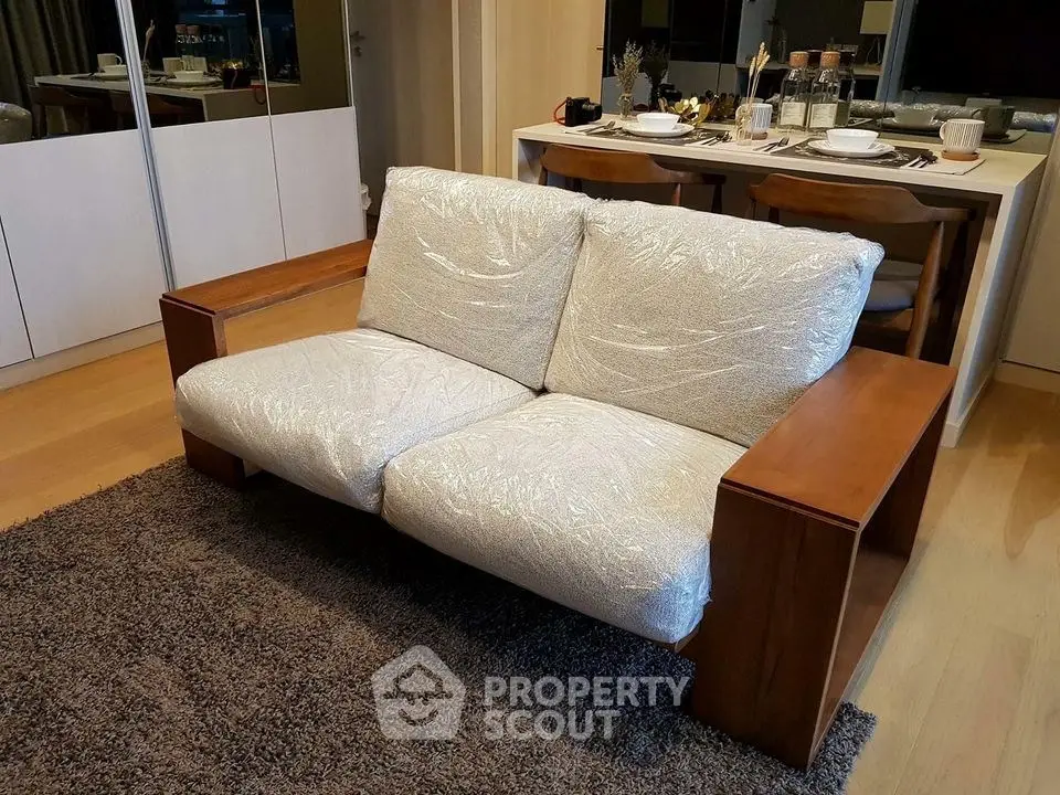 Modern living room with stylish sofa and elegant dining area, perfect for urban living.