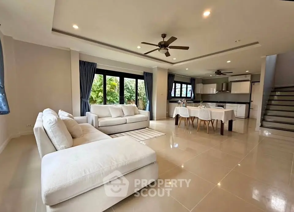 Spacious open-plan living room with modern kitchen and elegant dining area