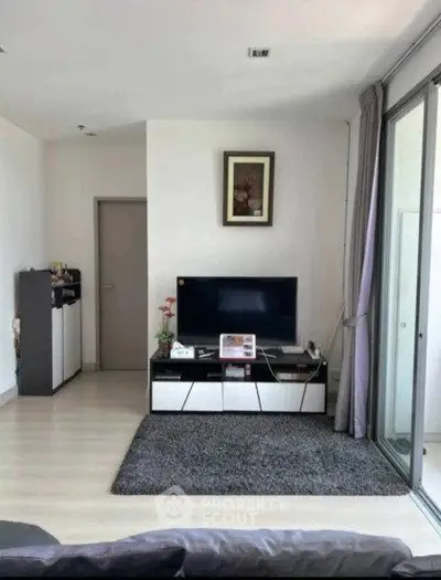 Modern living room with sleek TV stand and large sliding glass doors