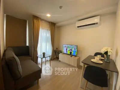 Cozy living room with modern decor, featuring a sofa, TV, and dining area, perfect for relaxation and entertainment.
