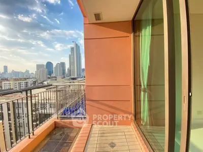 Stunning city view from a modern apartment balcony with glass doors and urban skyline.
