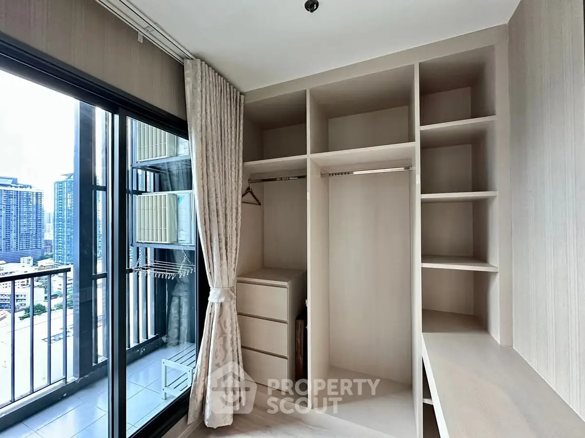 Spacious modern closet with balcony view in urban apartment