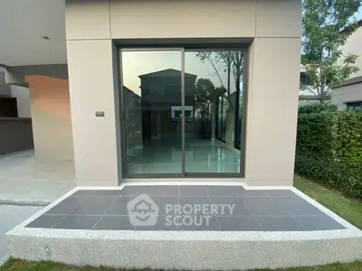 Modern exterior with sliding glass doors and sleek patio design