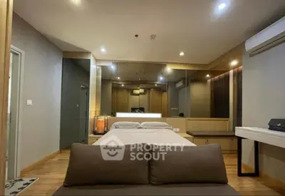 Modern bedroom with stylish decor and ambient lighting, featuring a comfortable bed and sleek furnishings.