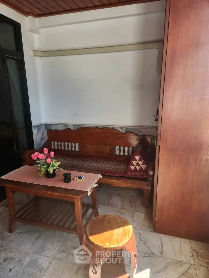 Charming patio with wooden furniture and cozy seating area