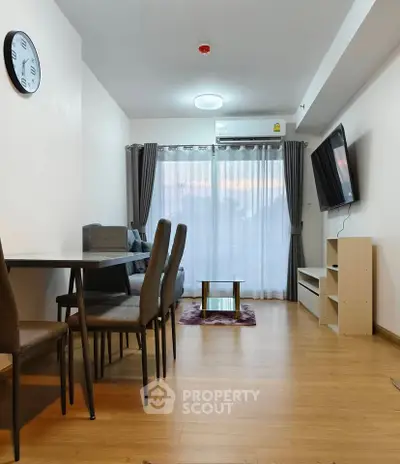 Modern living room with stylish furniture and wall-mounted TV in a cozy apartment