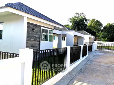 Modern single-story homes with sleek design and manicured lawns in a serene neighborhood.