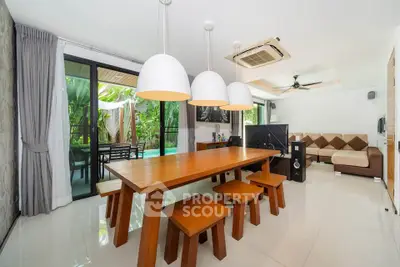 Spacious modern living room with dining area and pool view, perfect for entertaining.
