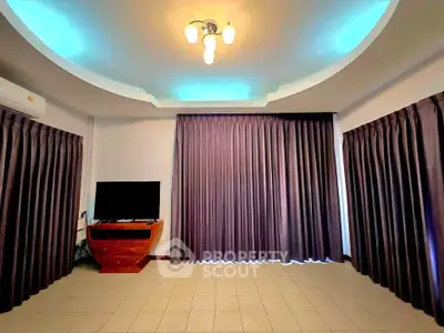 Spacious living room with modern lighting and large windows