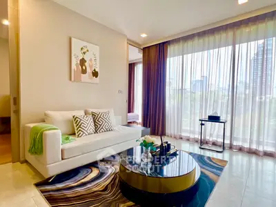 Luxurious living room with modern decor and large windows offering stunning city views.