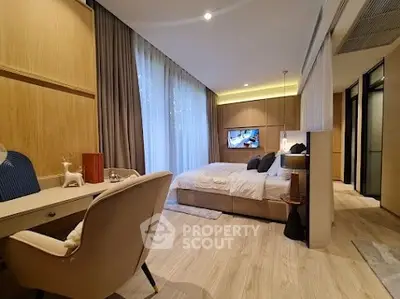 Luxurious modern bedroom with elegant decor and large windows for natural light.