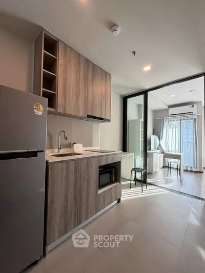 Modern kitchen with wooden cabinets and open layout in bright apartment