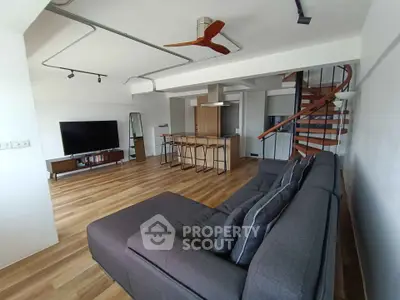 Spacious modern living room with open kitchen and spiral staircase