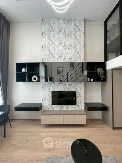 Modern living room with sleek black shelves and marble accent wall